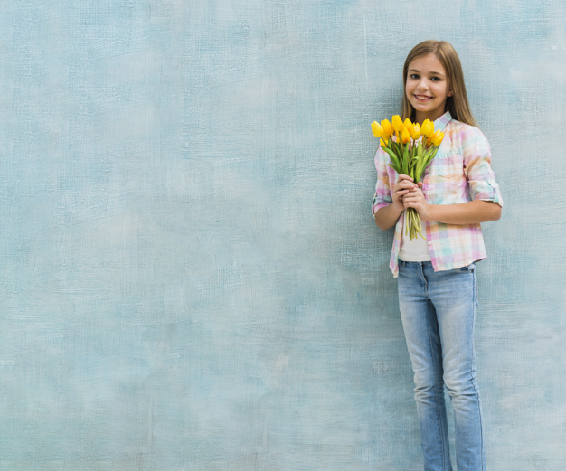 one,copyspace,leaning,innocent,freshness,against,bunch,joyful,little,cheerful,small,blonde,casual,single,childhood,standing,looking,smiling,pretty,alone,holding,lifestyle,portrait,beautiful,happiness,tulip,female,sweet,person,backdrop,yellow,human,child,kid,wall,happy,smile,cute,beauty,girl,blue,fashion,children,hand,flowers,people,flower,background