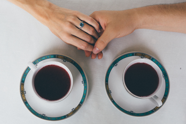 black coffee,caffeine,close-up,coffee,coffee cup,colors,cup of coffee,cups,hands,holding hands,liquid,ring,round,saucers,table