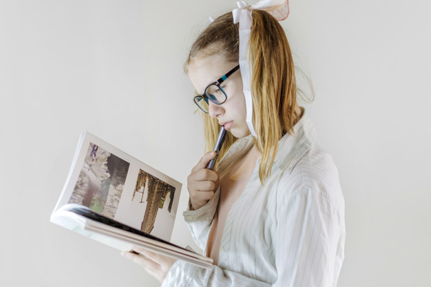 ribbon,people,book,hand,education,girl,hair,beauty,cute,kid,child,study,pen,person,exercise,reading,life,think,stand,knowledge,female,young,learn,holding hands,beautiful,portrait,up,read,cute girl,lifestyle,eyeglasses,hobby,look,pretty,stylish,childhood,hold,casual,blonde,side,little,ponytail,concentration,waist,long,posing,innocent,adorable,closeup,indoors,innocence,waist up