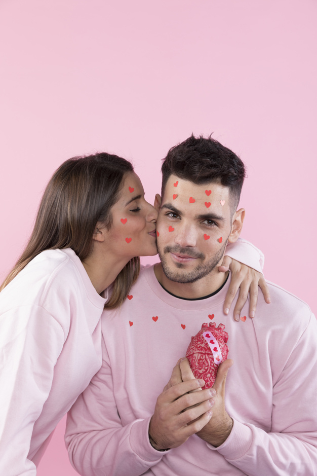 background,heart,love,ornament,woman,paper,camera,man,sticker,pink,rose,space,face,celebration,valentine,happy,event,couple,pink background,fun,decorative,symbol,model,lady,studio,hearts,love background,cloth,female,together,woman face,young,background pink,celebration background,sweater,happiness,faces,love couple,paper background,heart background,positive,male,guy,kissing,tradition,smiling,copy,looking,wear,leisure,handsome,casual,cheerful,pleasure,tenderness,indoors,at,copy space,looking at camera,with