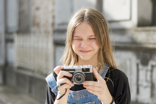 Young Beautiful Woman With Retro Camera Hipster Style Outdoor Shot