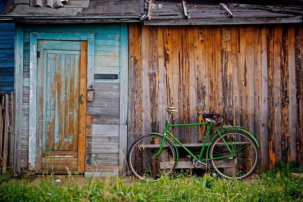green bike,wood,shed,shack,grass,rustic