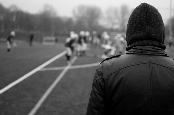 football,field,sports,athletes,spectator,leather jacket,hat,toque,beanie