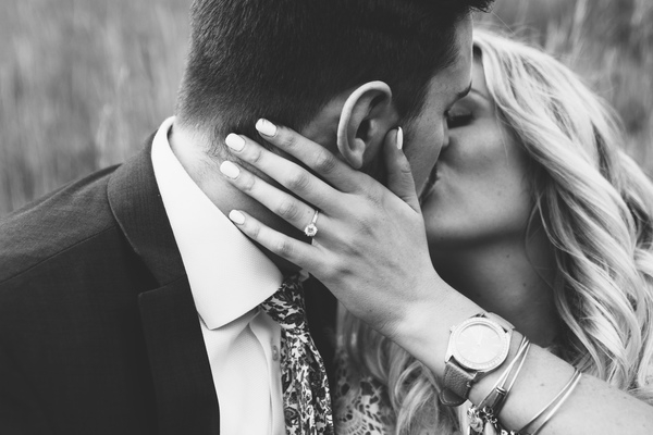 bride,groom,girl,woman,guy,man,kissing,couple,romance,romantic,love,engagement,ring,watch,blond,beauty,black and white,suit