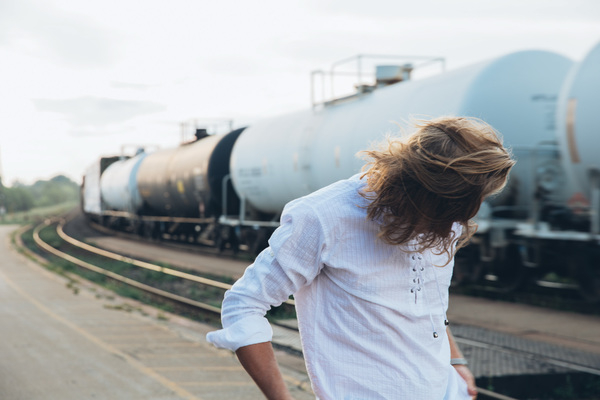 20-25 year old,blur,platform,railroad,speed,structure,track,young,background,blond,caucasian,city,commuter,departure,dynamic,fast,journey,long haired,look over shoulder,man,motion,rail,railway,selective focus,steel,train,transport,transportation