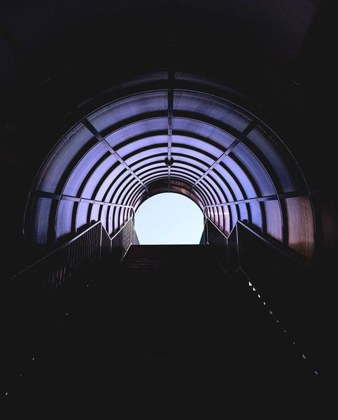 black background,dark,black,man,woman,male,like,hole,city,step,light,looking up,abstract,pattern,archway,tunnel,stair,dark,railing,city,urban,creative commons images