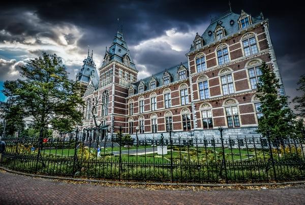 weather,trees,travel,town,tourism,storm,sky,rijksmuseum,outdoors,national museum,museum,monument,low angle shot,landmark,historic,gothic,fence,facade,european,dutch,dramatic,dark,culture,clouds,city,castle,building,architecture,ancient,amsterdam