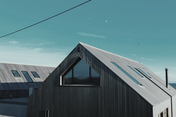 house,roof,wood,panels,windows,sky,clouds,lines,patterns,minimalist,blue,brown