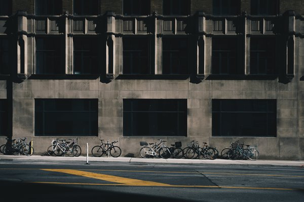  bikes,street,parked,shadows, stone building