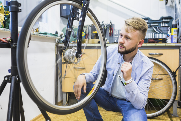 business,people,circle,man,sport,table,shop,bike,human,bicycle,person,business people,store,business man,round,wheel,mechanic,tire,working