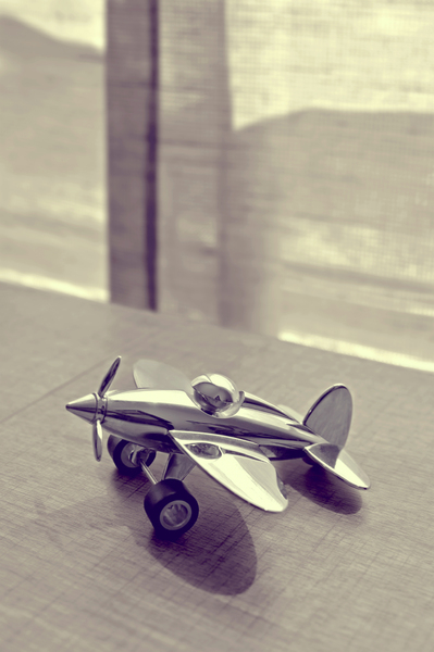 window,toy plane,toy,table,steel,shadow,plane,outdoors,metal,indoors,gray,decoration,black-and-white,biplane,airplane