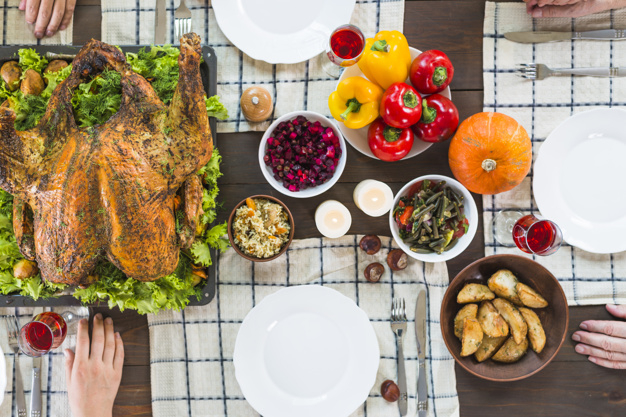 food,hand,family,thanksgiving,table,home,chicken,celebration,holiday,human,drink,candle,plate,vegetable,pumpkin,dinner,salad,human body,potato