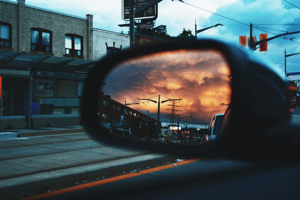 car,mirror,road,trip,travel,traffic,light,building,downtown,sky,clouds,transmission,line,sunset