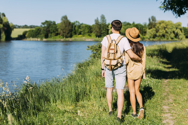 people,water,man,nature,grass,couple,person,hat,clothing,tourism,vacation,womens day,female,together,young,backpack,lake,path,view,hiking