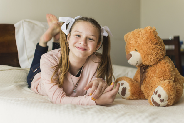 ribbon,people,house,animal,home,beauty,smile,happy,bear,furniture,child,person,bed,brown,toy,teddy bear,bedroom,young,pillow,expression
