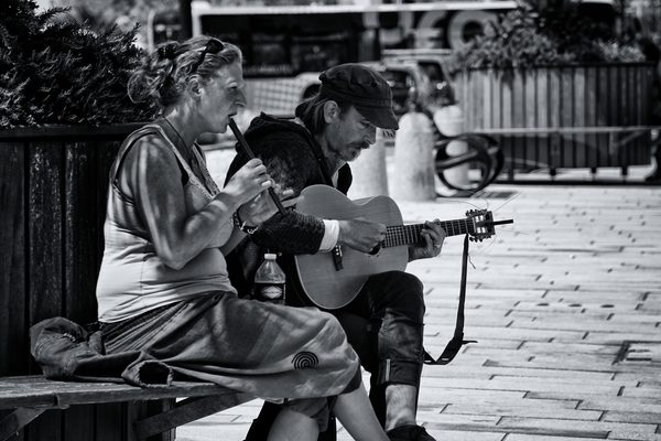woman,string instrument,street,people,musicians,musical instruments,music,man,guitarist,guitar,flute,black-and-white