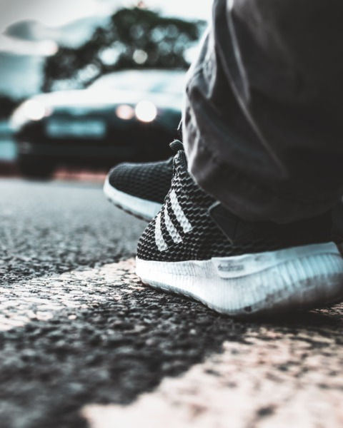 blur,blurred background,car,close-up,fashion,footwear,headlights,outdoors,person,road,roadside,shoes,sneakers,wear,Free Stock Photo