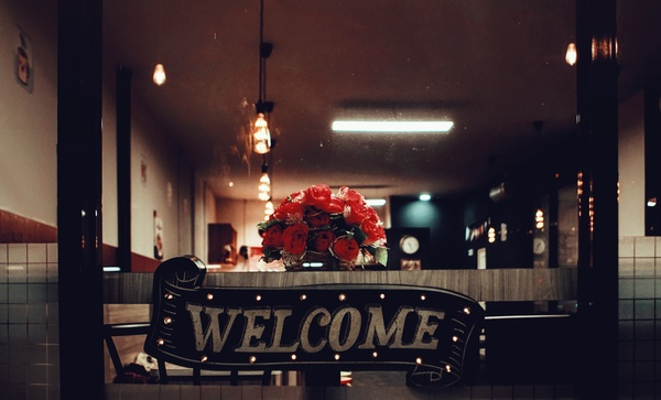welcome,sign,vintage,rustic,wood,business,coffee shop,flower,bouquet,furniture,glass,lamp,light,restaurant,signage