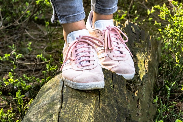 young,wood,woman,wear,walk,summer,suede,sporty,sports shoes,sneakers,shoes,shoe strap,pink,person,park,outside,outdoors,log,grass,girl,close-up,beautiful,balance