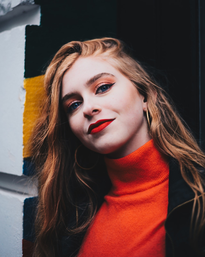 Close-Up Shot of a Woman in Turtle Neck Holding an Illuminating Heart ·  Free Stock Photo