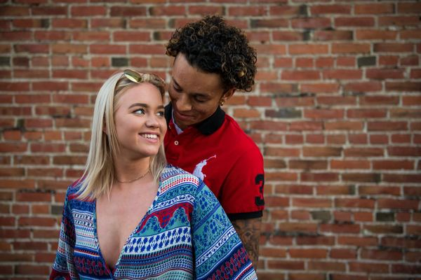 young love,woman,couple,couple,love,woman,relationship,couple,woman,man,male,woman,female,brick wall,cuddling,love,blonde hair,black skin,couple,outdoors,street,free images