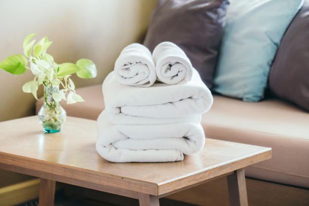 Premium Photo  Clean towels on table against color background