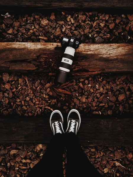 camera,dark,dslr,footwear,ground,lens,lenses,outdoors,person,railroad,railway,rocks,shoes,top view,track,wear,wood,Free Stock Photo