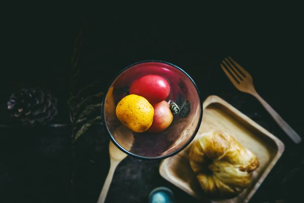 food,fruit,healthy,gold,yellow,food,black,food,fruit,fruit,fork,spoon,plate,pastry,croissant,orange,tomato,create,make,topdown,colour