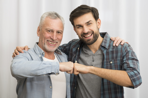 camera,man,happy,room,white,curtain,father,relax,cloth,care,fist,together,young,cool,elderly,positive,male,senior,guy,rest,parent,horizontal,smiling,looking,wear,comfort,leisure,hugging,handsome,casual,son,cheerful,aged,joyful,fists,indoors,at,fatherhood,looking at camera,bumping,with