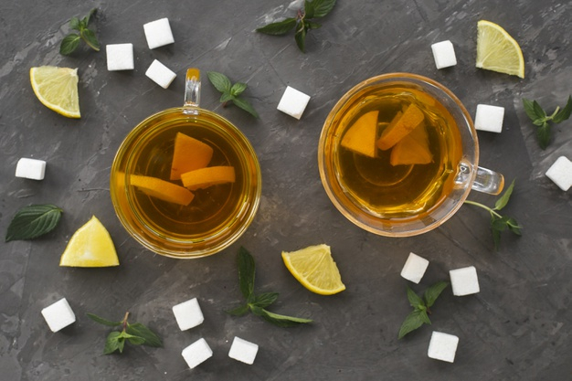lay,aromatic,sugar cubes,textured,lemons,textured background,cups,horizontal,flat lay,beverage,cubes,herbal,mint,herbs,liquid,transparent,sugar,hot,healthy,drink,flat,tea,health,background