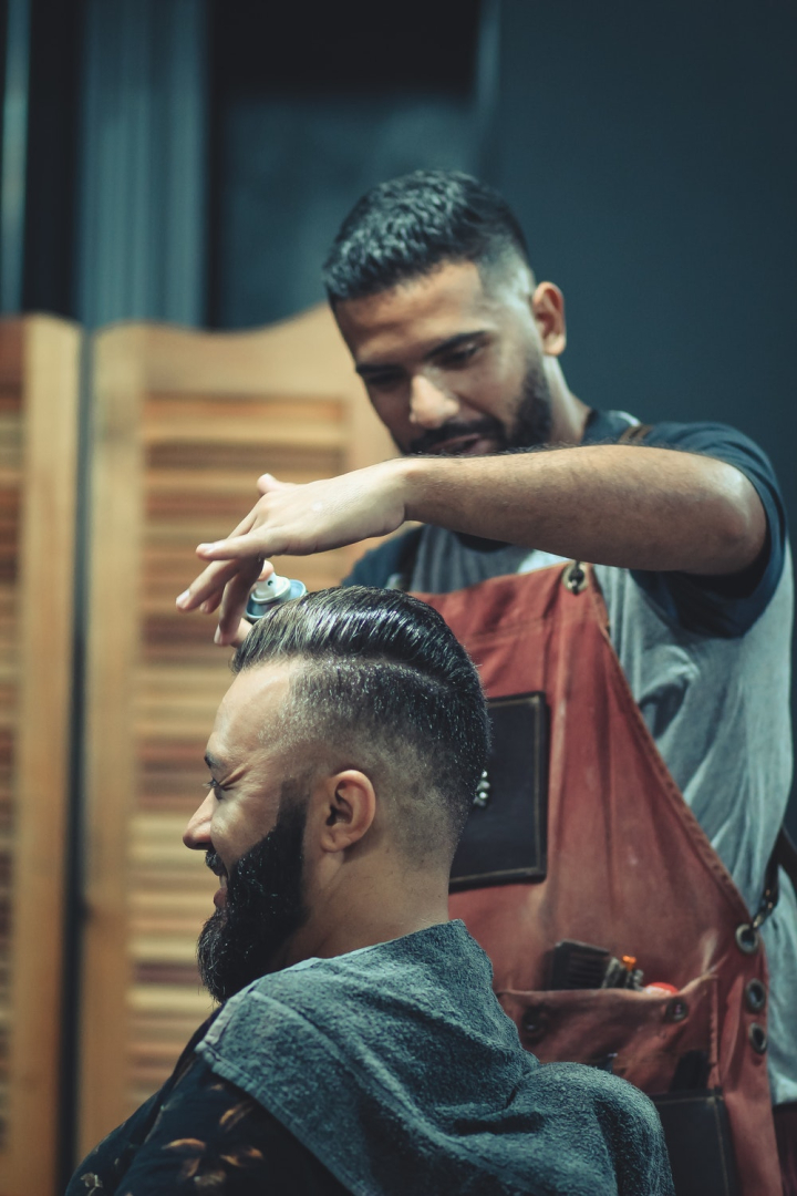 barber,barbershop,blurred background,facial expression,facial hair,hairdo,hairstyle,indoors,men,model,people,photoshoot,side view,wear