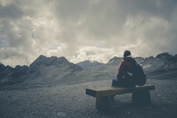 alone,clouds,cloudy,landscape,lonely,mountain range,mountains,person,rocks,sitting,solo,Free Stock Photo