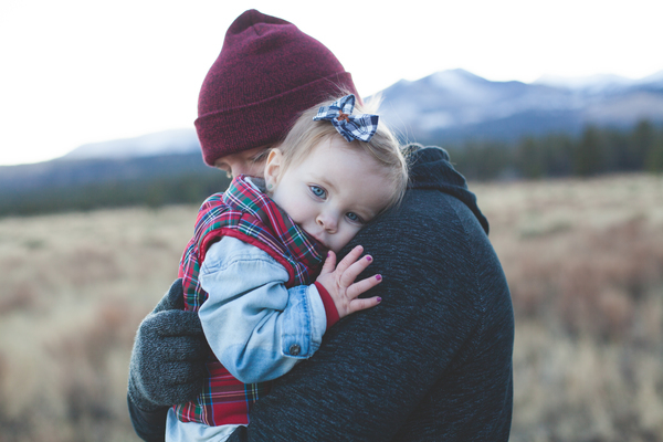 family,child,cuddle,hug,hike,trail,walk,woman,baby,people,tired,hat,field,grass,cold,frost,mountain,snow,cloudy