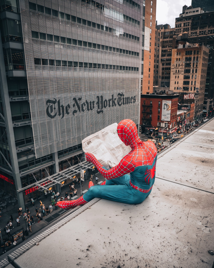 city,costume,downtown,halloween,man,new york city,newspaper,person,reading,spiderman,street,superhero,the new york times,urban