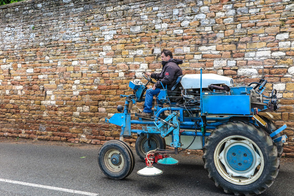 blue,driving,europe,farm,farming,machine,tractor,vineyard,wall,worker,agricultural,agriculture,france,machinery,masonry,road