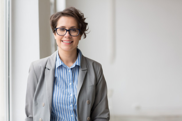 midaged,toothy,formalwear,specialist,brunette,looking,smiling,pretty,adult,profession,businesswoman,successful,executive,eyeglasses,manager,professional,young,vision,leader,employee,job,corporate,person,elegant,happy,office,woman,business