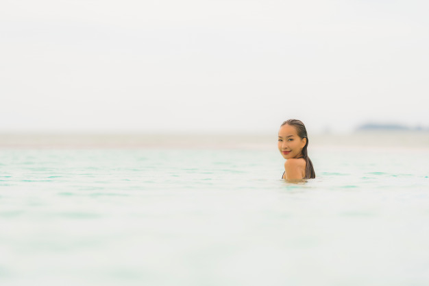 Free Photo  Portrait of cute girl in bikini standing on the beach