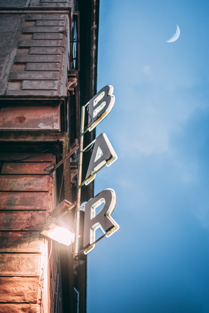 abandoned,architecture,bar,blue sky,building,bulb,business,daylight,evening,letters,light,low angle shot,moon,outdoors,pub,sign,signage,sky,street,travel,vertical,word
