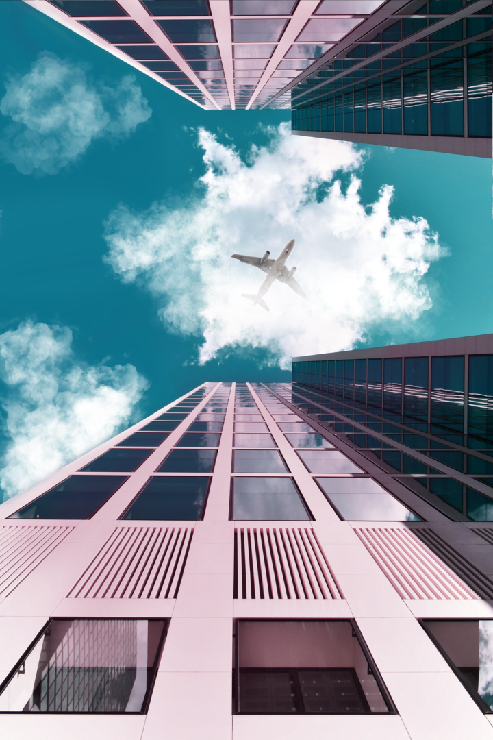 above,aircraft,airplane,architectural design,architecture,buildings,business,city,clouds,contemporary,daylight,engineering,exterior,flight,fly,glass items,glass panels,glass windows,high,low angle shot,modern,offices,over,perspective,reflection,sky,skyline,skyscrapers,tall,tower,travel,urban,windows