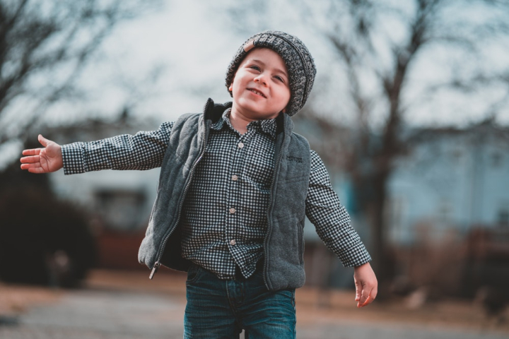 alone,beanie,boy,child,childhood,facial expression,happy,innocence,kid,little boy,photoshoot,posing,selective focus,smile,walking