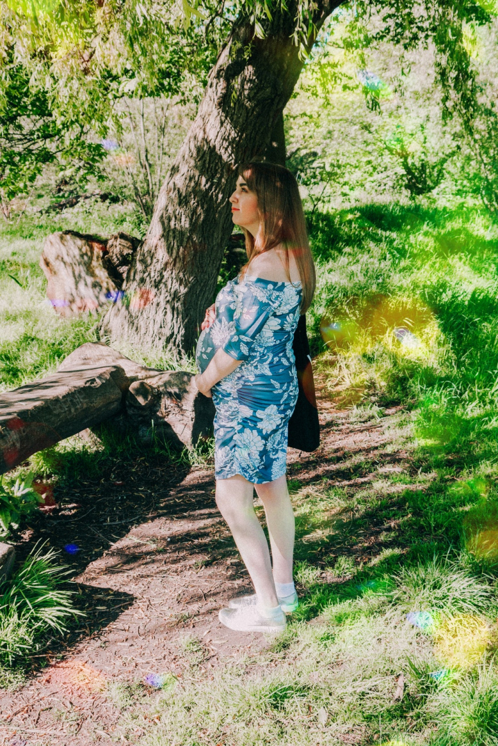 beautiful,daylight,dress,expectant,expecting,fashion,floral dress,garden,grass,landscape,leisure,maternity,mother,motherhood,outdoors,park,person,photoshoot,pose,pregnancy,pregnant,relaxation,summer,trees,wear,woman,wood