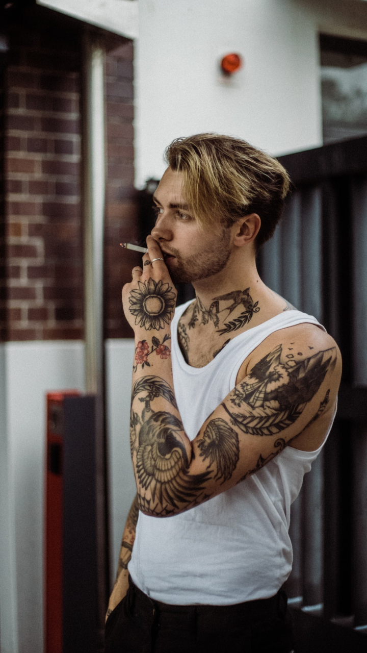 casual,cigarette,cool,facial expression,facial hair,fashion,fine-looking,good-looking,guy,indoors,looking,male,male model,man,masculinity,menswear,model,outfit,pensive,person,photoshoot,portrait,pose,punk,serious,sexy,smoking,style,tattoo,wear