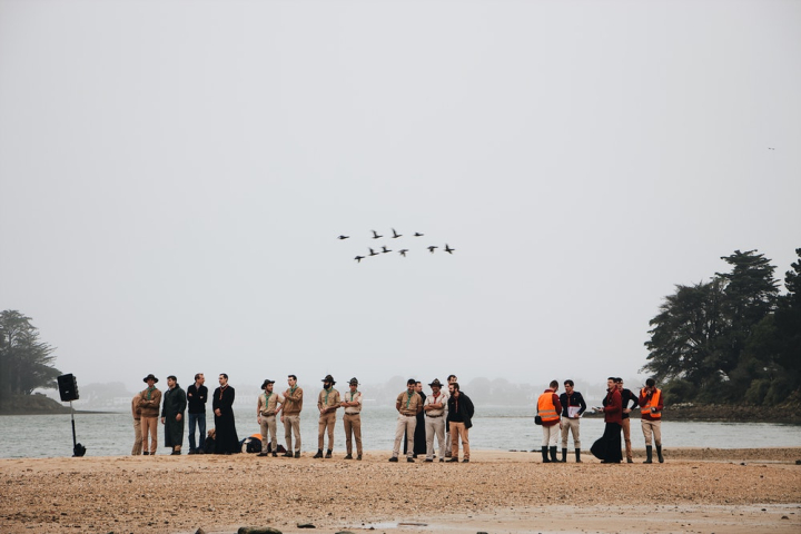beach,birds,daylight,flock of birds,flying,group,group together,landscape,leaders,leisure,men,ocean,outdoors,people,recreation,sand,scouts,sea,seashore,shore,team,together,travel,trees,uniform,water
