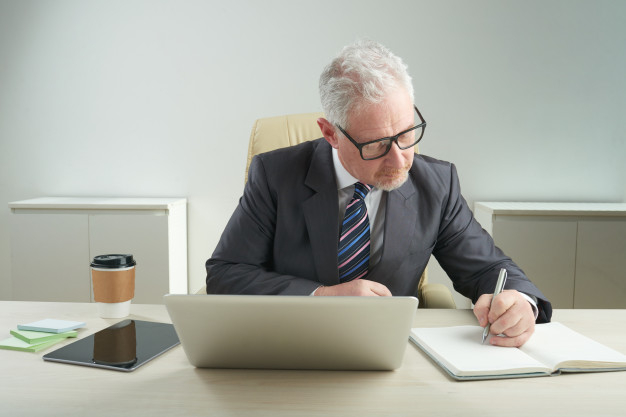 Writing note showing Time To Retire. Business concept for Take the  pensioner status stop working in elderly old enough Businessman in blue  suite stand Stock Photo - Alamy