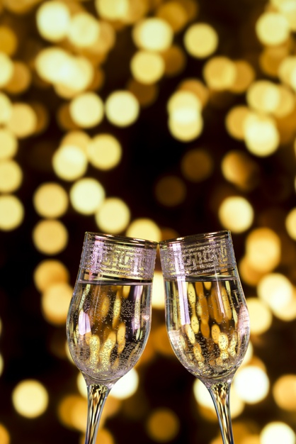 Close Up Glasses Of Clinking Glasses Of Champagne With Lighting