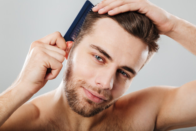 Free: Close up portrait of a smiling man combing his hair Free Photo -  
