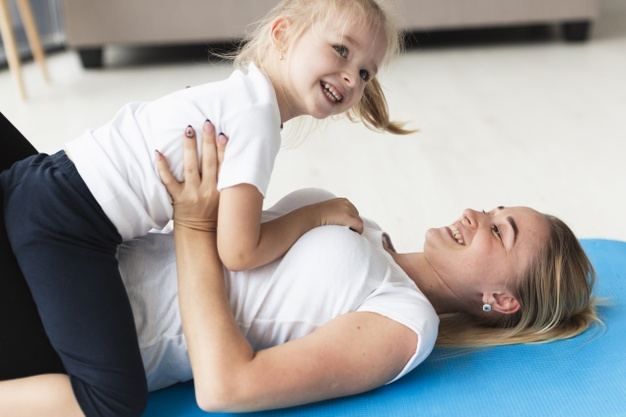 Free: Happy family of mother and daughter at home on yoga mat Free Photo 