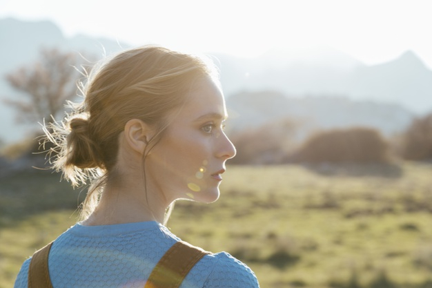 silhouette of a beautiful girl at sunset in a field, face profile of young  woman on nature Stock Photo