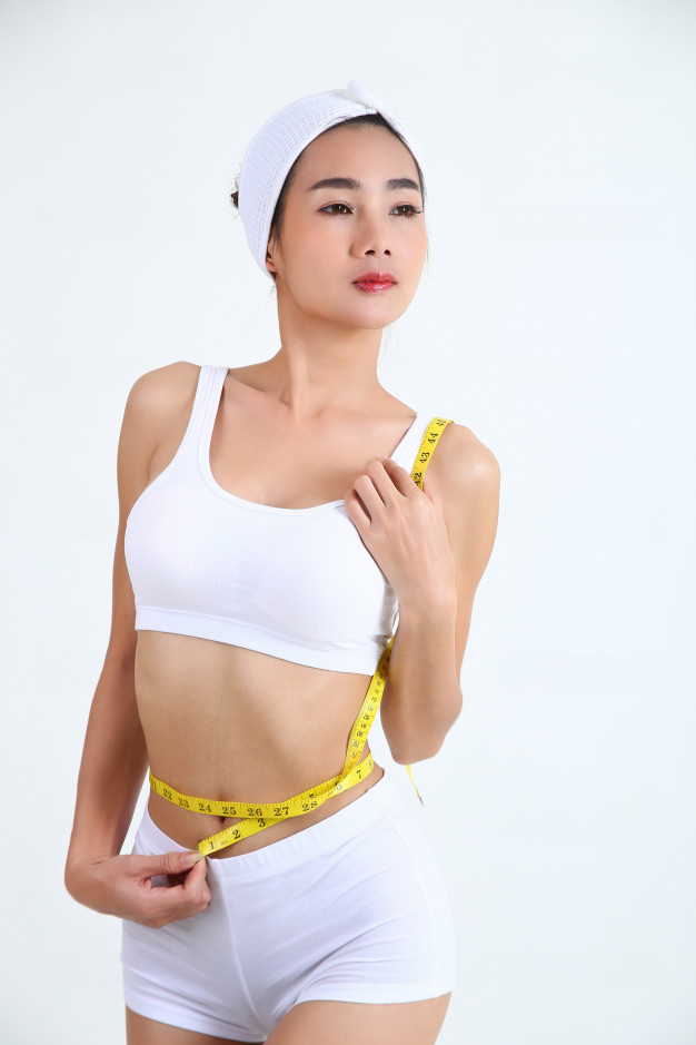 Young Girl In Bras Measures Belly With Tape Stock Photo, Picture