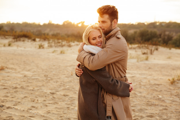 Portrait of happy cute couple in love hugs and smiling Stock Photo